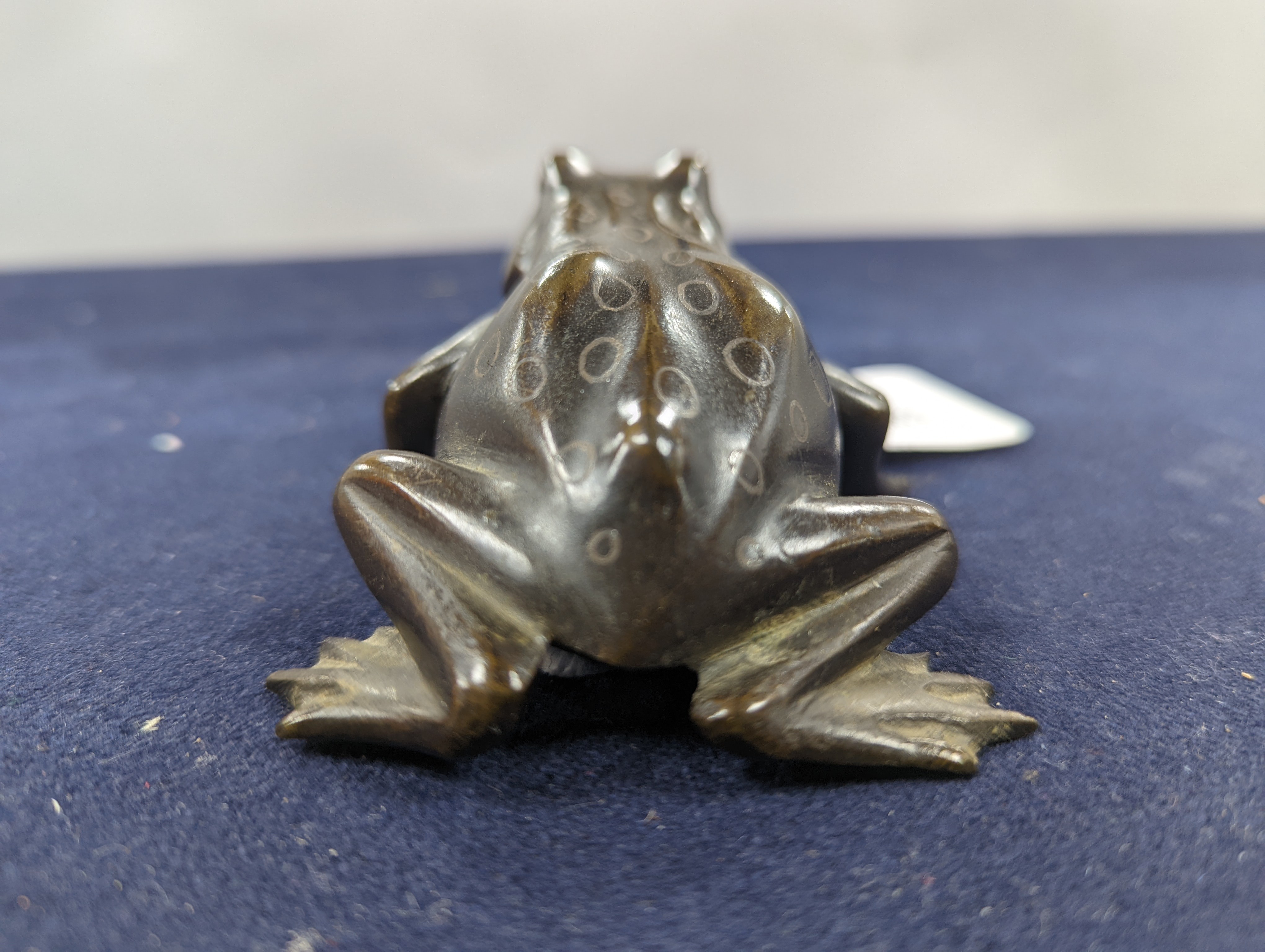 A Chinese bronze group of Liu Hai and a toad, wood stand and a bronze figure of a dog, 9cm